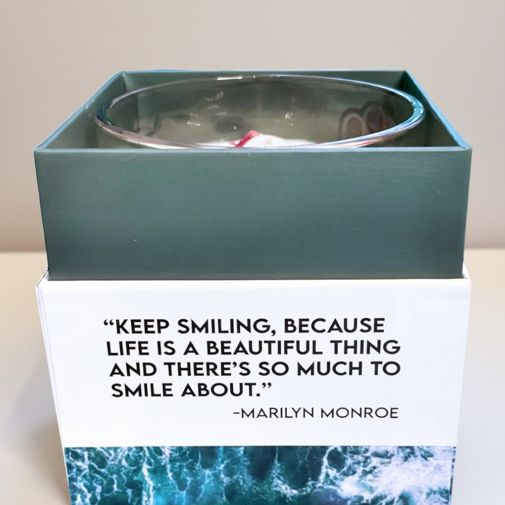 Cloque and Dagger Bohemian Rebel Lover candle in a glass vessel with a Hamsa hand symbol, featuring a quote by Marilyn Monroe.