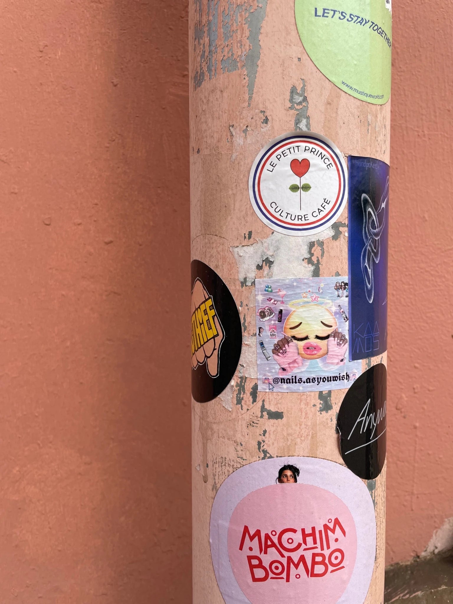 A street column layered with stickers and texture